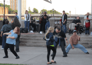 Individuals enjoying music by Flame the band