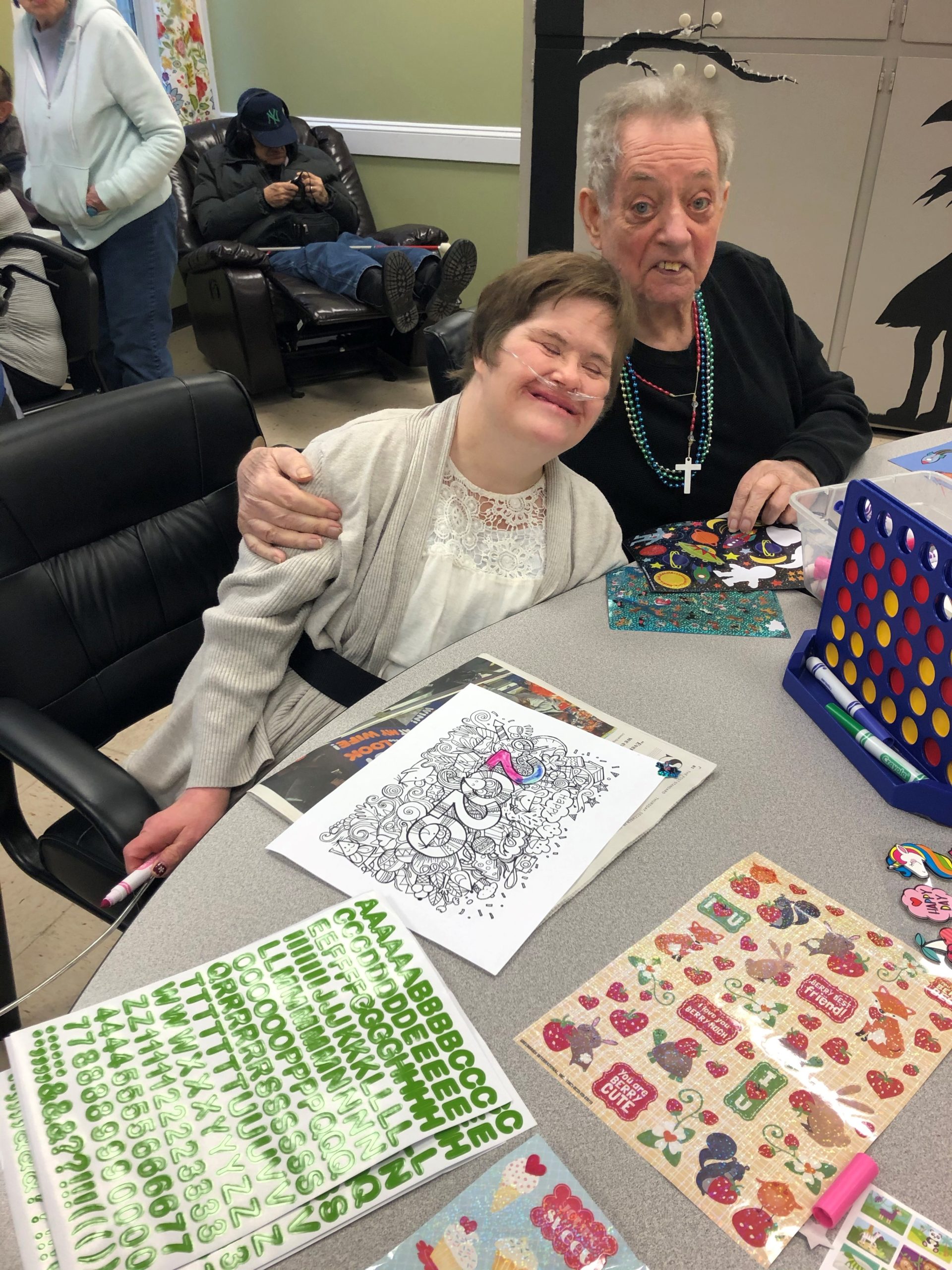 Two friends with disabilities hugging